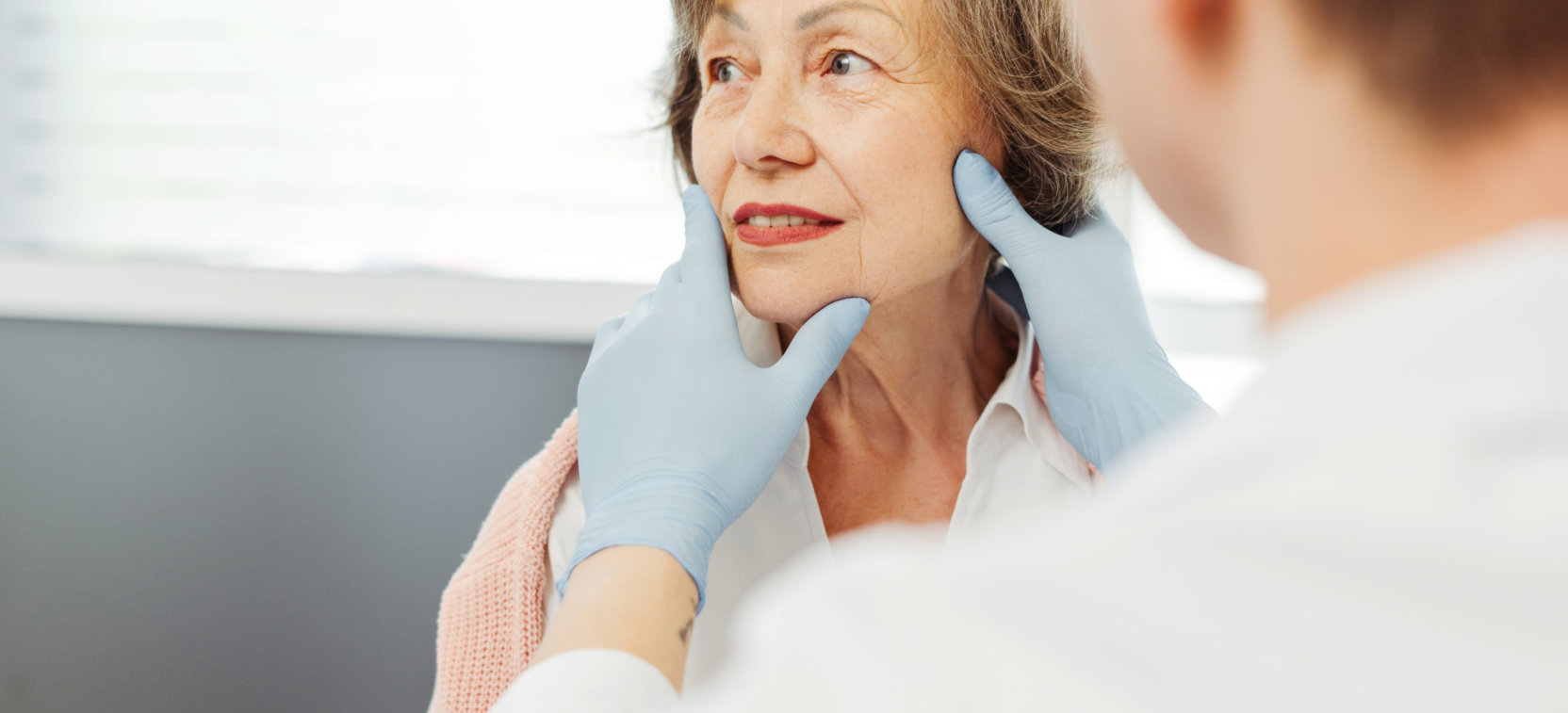 doctor checking elderly woman