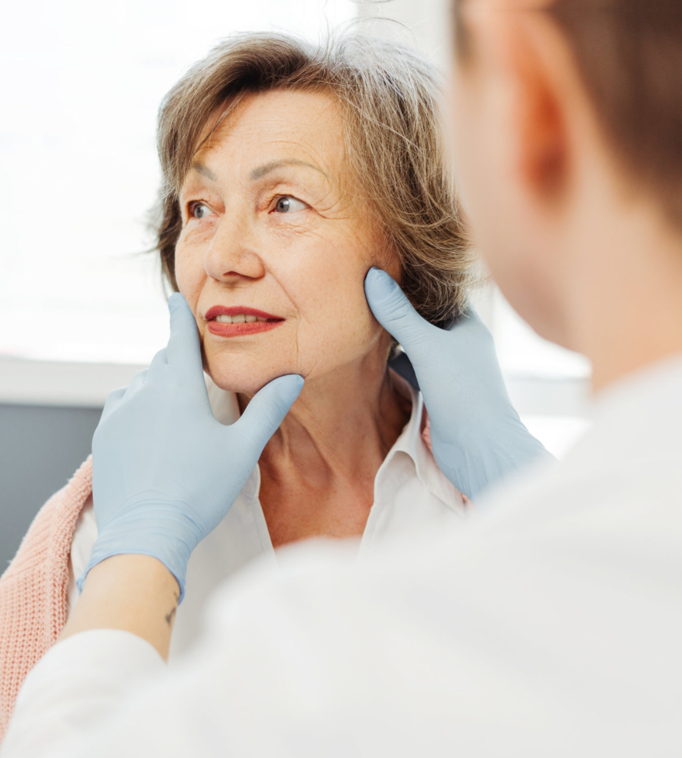 doctor checking elderly woman