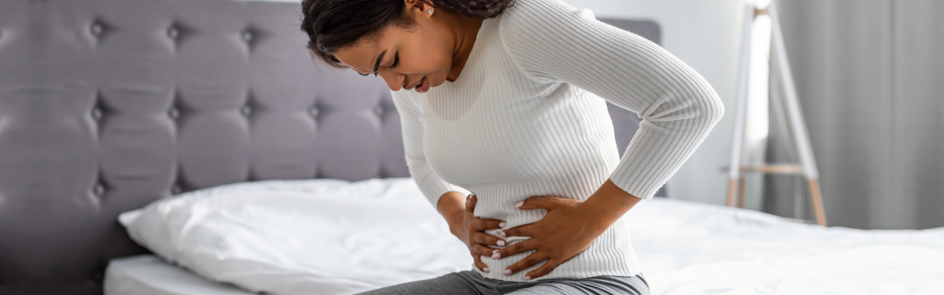 woman holding her stomach